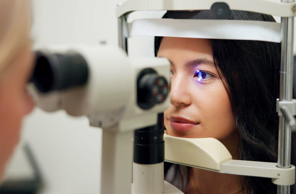 A woman is at her optometrist's office for an eye exam to assess for myopia.