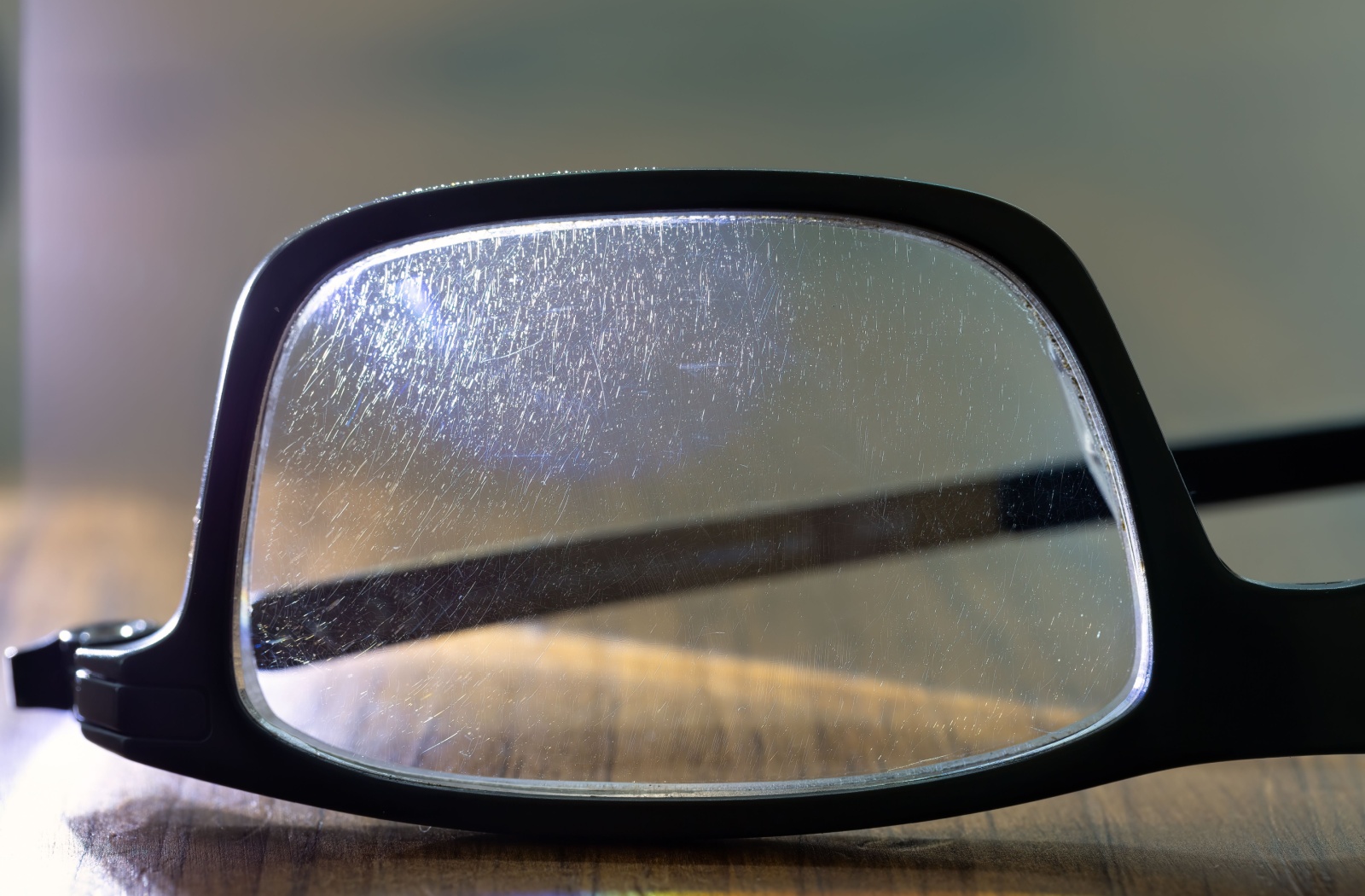 A close up of a pair of glasses with micro scratches in them.