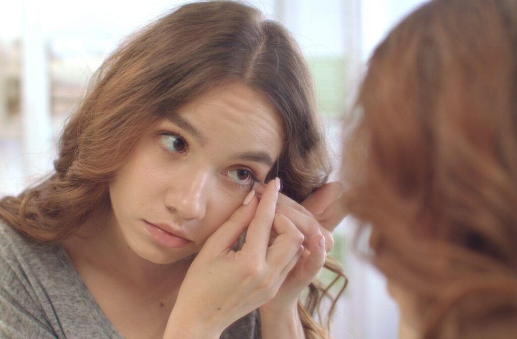 A person carefully removing their contact lenses at the end of the day.